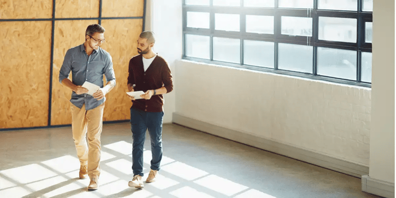 Image of two men in an empty office space